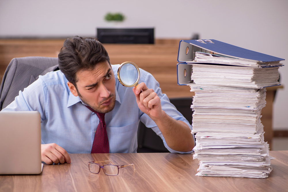 Young male employee unhappy with excessive work in the office