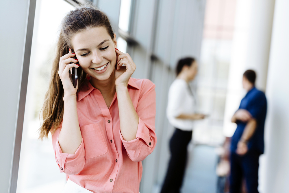 Beautiful women using phones and talkin during break